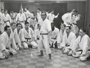Martial arts class with instructor demonstrating technique.